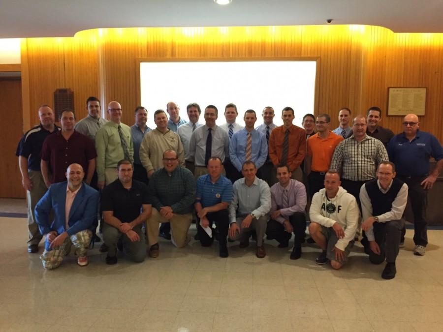 The male teaching staff poses together to show off their freshly shaven faces on November 1.
