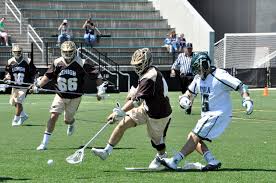 Coach Souders picks up a ground ball during a game with Lehigh during the 2014 season.