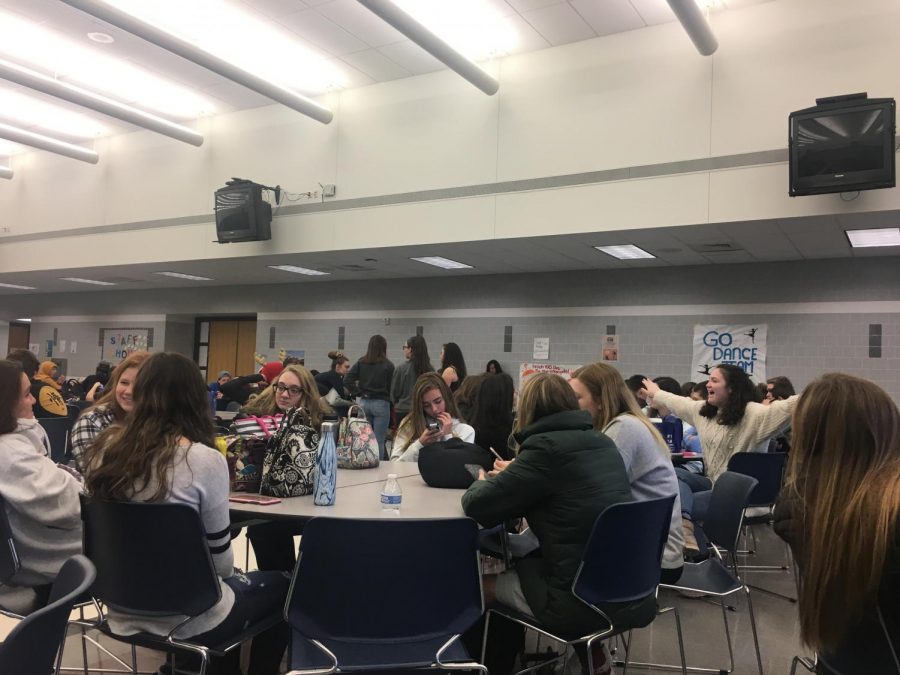 Students eat and converse during their lunch period.