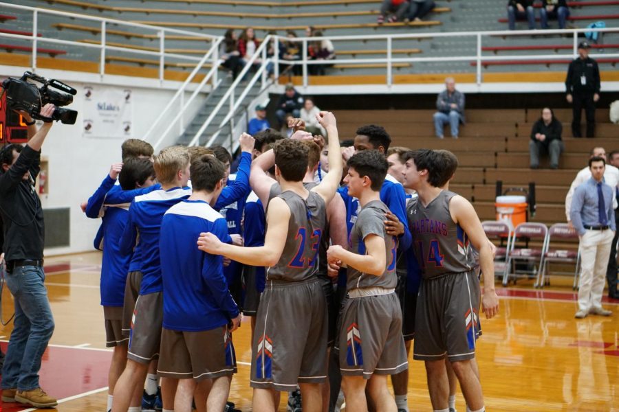 The team huddles up before a District XI playoff game in February. They would go on to win the contest 72-65 behind 26 points from Chris Andrews. 
