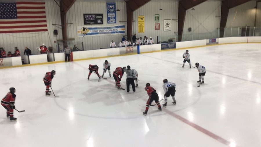 The Southern Lehigh Hockey Team in action as two players face off at the beginning of the game. 