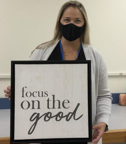 Mrs. Mullay shows off her favorite sign to remind herself and others to stay positive.