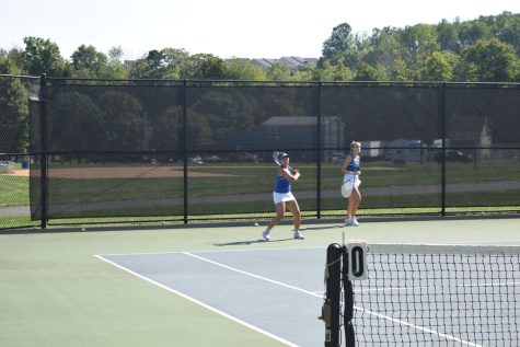 Tennis players warm up for match.