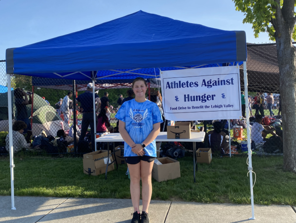 Sophomore Ellie Kane sets up her club’s tent to gather donations for local food pantries.