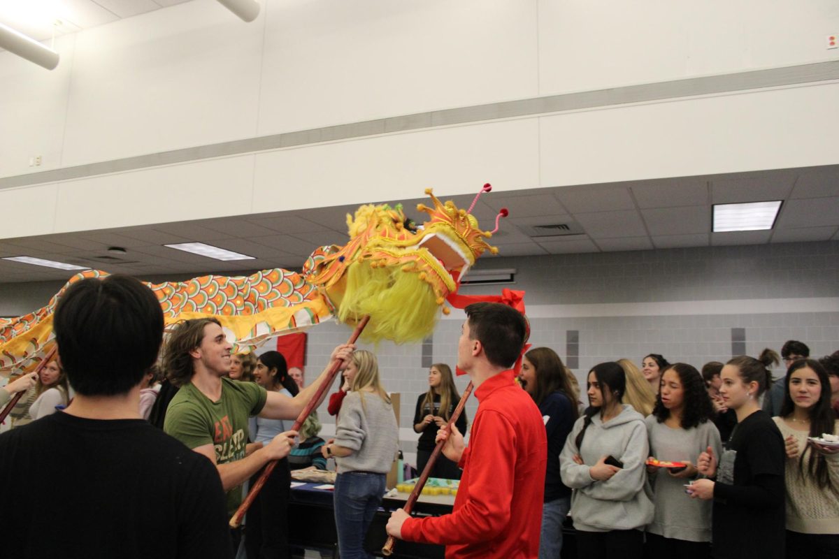 Students peform a traditional dragon dance at the 2023 Multicultural Fair.