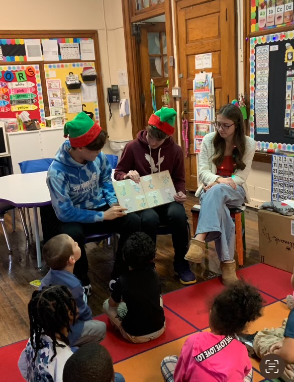 Winter Track athletes read to kindergarteners at Jackson Elementary. 