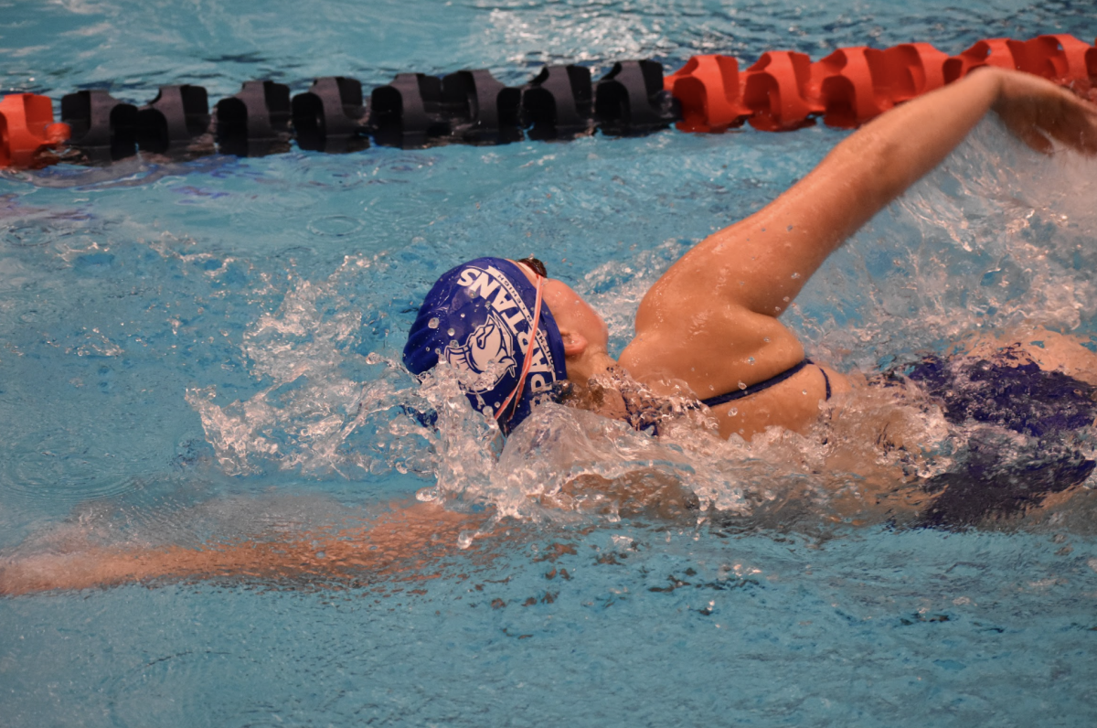 Sophomore Cameron Johnson swims diligently, ready to overtake her opponents.