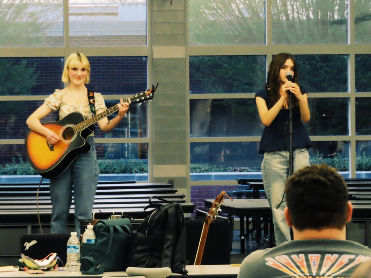 Lilianna Weber plays guitar as Arianna Fogerty sings